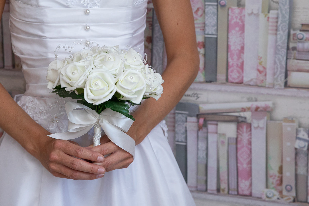 Bride holding a Lilli Rose cream rose and pearl wedding posy