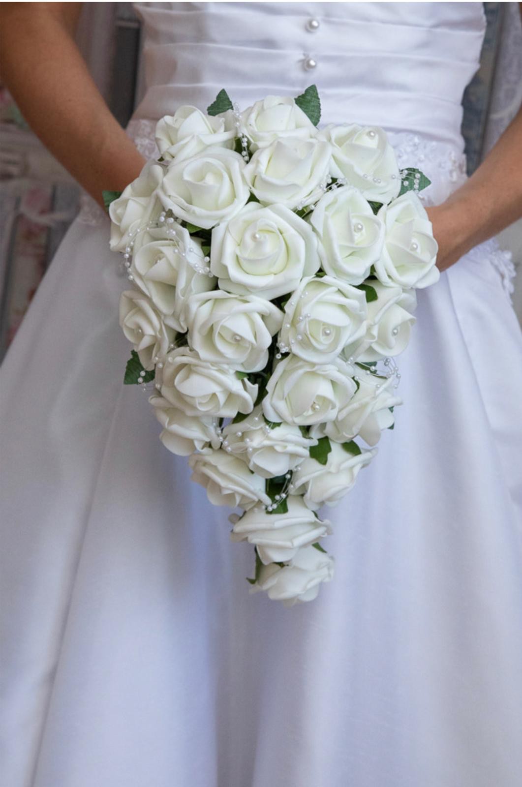Bride holding a cascading ivory rose bouquet