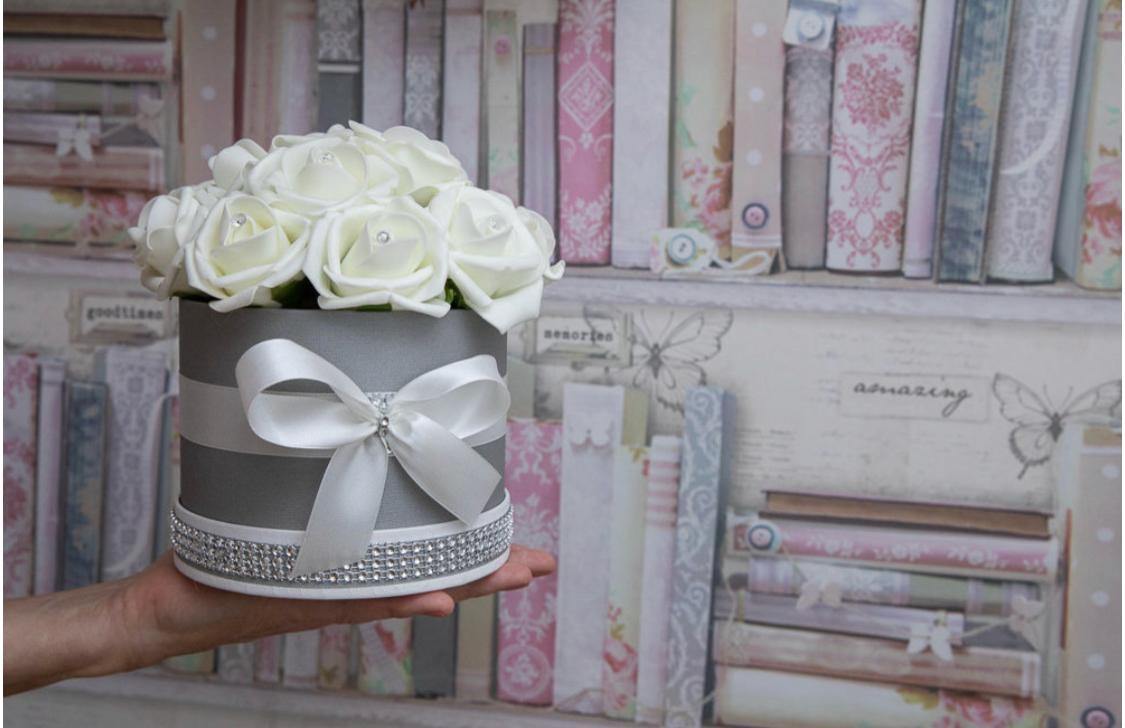 Ivory roses in a grey hat box with a white satin bow